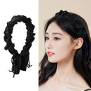 Black pleated fabric headband on white background, front view