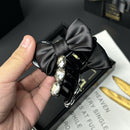 Detail shot of satin ribbon stitching and bow symmetry