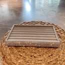 Overhead photo of 9-compartment tray with assorted rings and ear cuffs