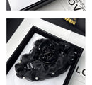 Product packaging with hair clip visible
