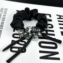 Close-up of square-cut crystal detail on satin ribbon bow