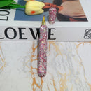 Close-up of crystal detailing on metal cap and grip of wooden pen