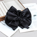 Side angle showing smooth satin bow and sturdy shark clip mechanism