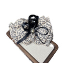 Close-up of satin ribbon bow and delicate floral fabric detail