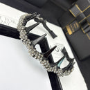 Side angle showing contoured wave shape and satin mesh texture of hair band