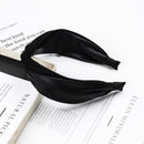 Front view of wide leather headband in black on white background