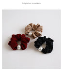 Detail shot of machine-stitched pearl attachment on coffee brown band