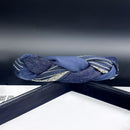 Navy headband styled on model with loose wavy hair and neutral outfit