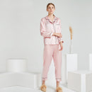 Dusty pink silk pajama set folded neatly on a surface
