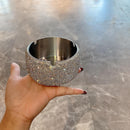 Close-up of reflective diamond-like surface detailing on silver ashtray