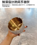 Minimalist flat lay with ashtray, matches, and leather journal on linen cloth