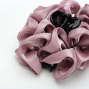 Flat lay of tulle hair clip beside dried lavender sprigs and linen napkin