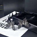 Close-up of sparkling crystal embellishment on butterfly silhouette