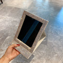 Mirror reflected in a larger wall mirror to demonstrate versatility and scale