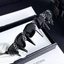 Side angle of black headband showing braided texture and pearl placement