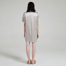 Three-quarter back view showing silk drape and short sleeves