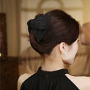 Side angle showing spring mechanism and satin texture of Paris-inspired hair clip