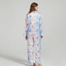 Side view of the model lounging in the silk pajama set