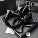 Side angle showing curved metal frame and satin surface texture