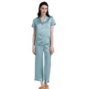 Front detail view of teal blue silk pajama set on plain background