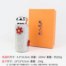 Front view of red floral diamond-embellished stainless steel tumbler on white background