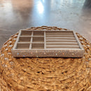 Interior view with 6-compartment foam tray holding stud earrings and small pendants