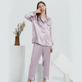 Lavender silk pajama set displayed on model in minimalist studio setting