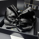 Front view of black satin starry sky claw clip on white background