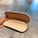 Top-down shot of open white eyeglass case revealing soft fabric interior and spacious compartment