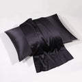 Black silk pillowcase with rich luster on white backdrop