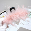 Side angle showing layered black feathers and mink fur accent on shark clip