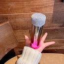 Tumbler placed on car dashboard with sunroof open and soft lighting