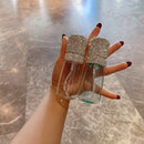 White spray bottle held in hand demonstrating comfortable grip and fine-mist action