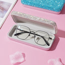 Lifestyle image of leather eyewear case placed beside designer sunglasses on marble surface