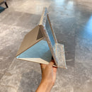 Mirror folded flat for storage—showing protective backside and slim profile