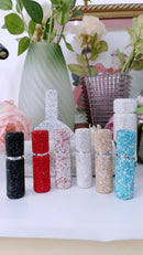 Travel-ready setup: atomizer, mini rollerball, and scent journal on desk