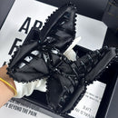 Black bow claw clip styled in a low chignon hairstyle