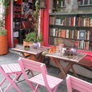 Ashtray in silver finish beside vintage lighter and cigar cutter on brass tray