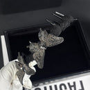 Black butterfly hair comb styled in a low chignon hairstyle