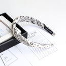 White cashew print sponge headband on neutral background