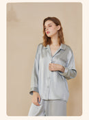 Folded silk pajama set tied with a ribbon in gift-ready packaging