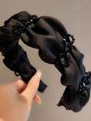 Lifestyle shot of black butterfly headband styled with minimalist outfit