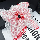 Side angle showing elasticity and layered lace construction of hair tie