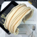 Side angle showing texture and crystal placement on black mesh hair band