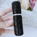 Atomizer in travel toiletry bag with passport and sunglasses