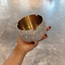 Ashtray in gold finish on dark charcoal fabric for contrast and warmth