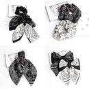 Close-up of cashew motif detail on black scrunchie fabric