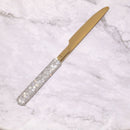 Flatware set arranged on rustic wooden table with linen napkin — lifestyle dining scene