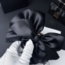 Detail of shark clip teeth and satin bow attachment point