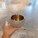 Lifestyle shot of ashtray on modern wooden desk with reading glasses and book